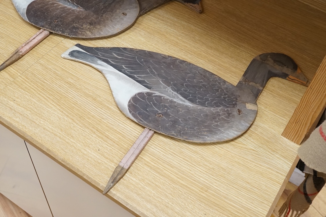 A pair of painted ply 'goose' profile decoys, 58cm high